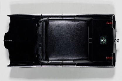 top view of a black model toy car on white background