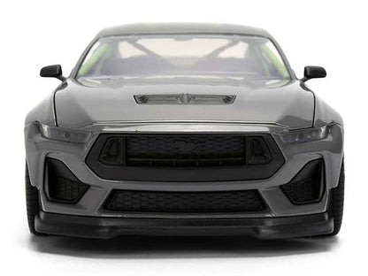 Front view of a gray car with a visible logo on a white background