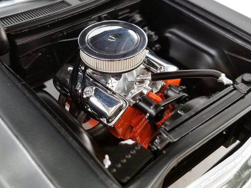 Car engine with a prominent air filter and red components.