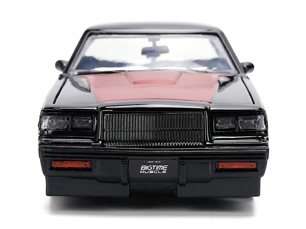 Model of a black muscle car with a pink hood on a white background