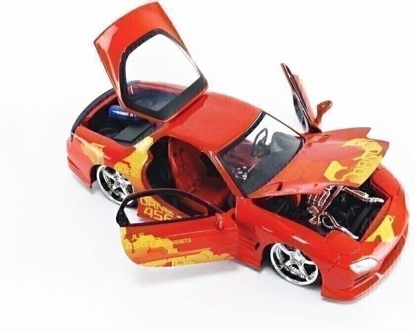 Red toy car with open doors on a white background