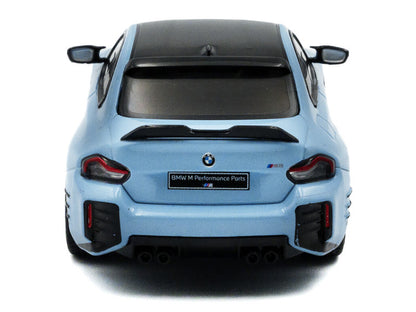 Back view of a light blue BMW car with visible branding on a white background