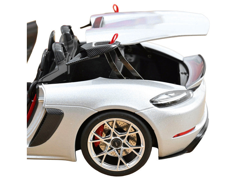 White sports car with open hood on a white background