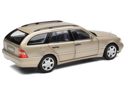 Model of a beige station wagon on a white background