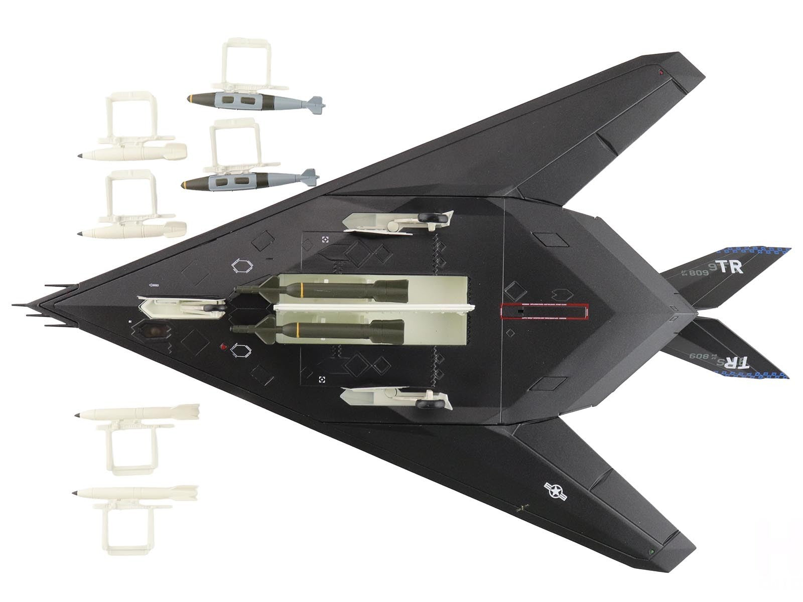 Black fighter jet model with attached missiles on a white background