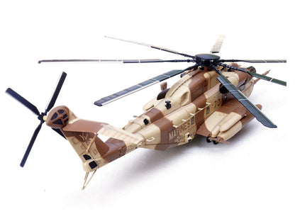 Model helicopter with camouflage design on a white background