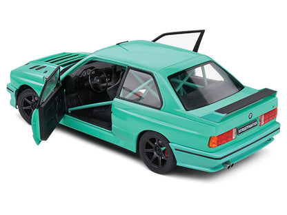 Green model car with open doors on a white background