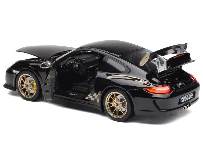 Black sports car model with open doors on a white background