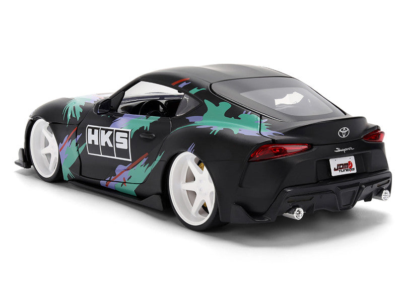 Black Toyota Supra with colorful graphics and HKS branding on a white background