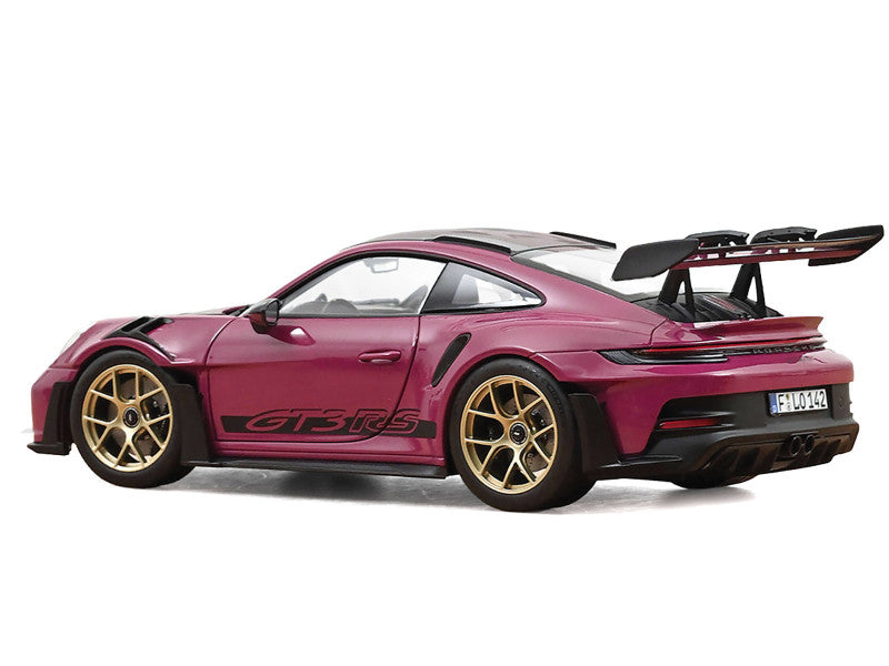 Pink sports car with gold wheels on a white background