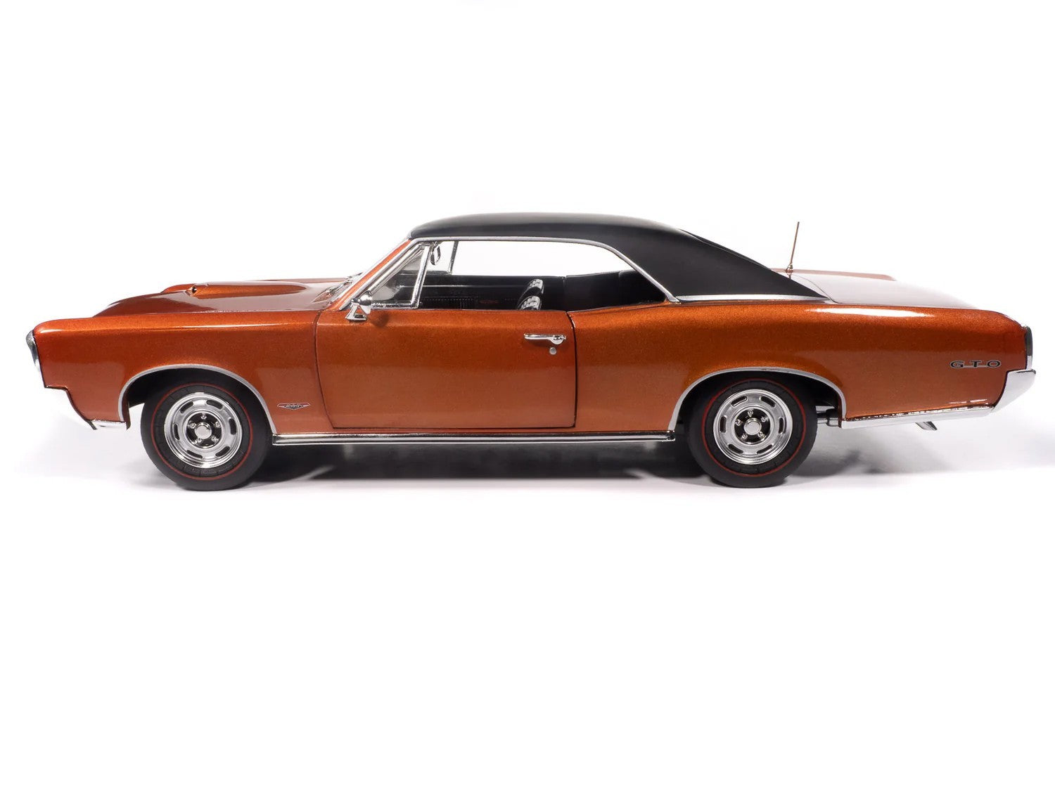 Side view of a classic orange muscle car with black roof on a white background