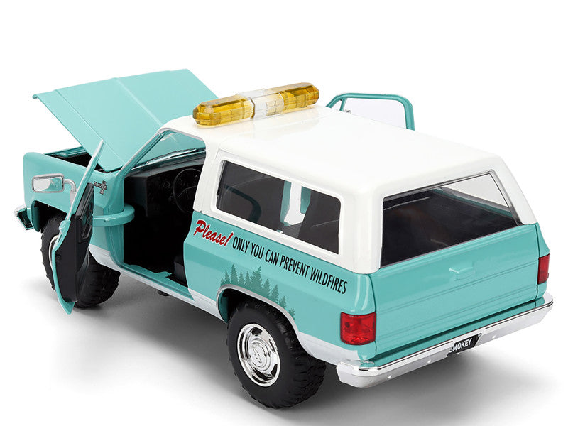 Model of a turquoise and white vehicle with open door on a white background