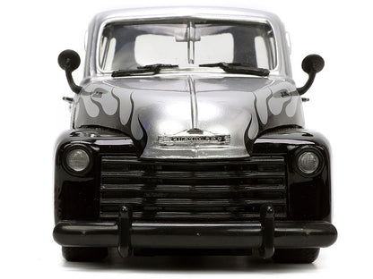 Front view of a black and silver vintage truck model on a white background