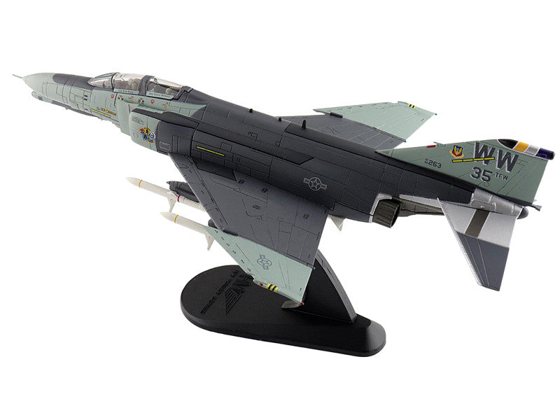 Model of a fighter jet on a stand with visible branding