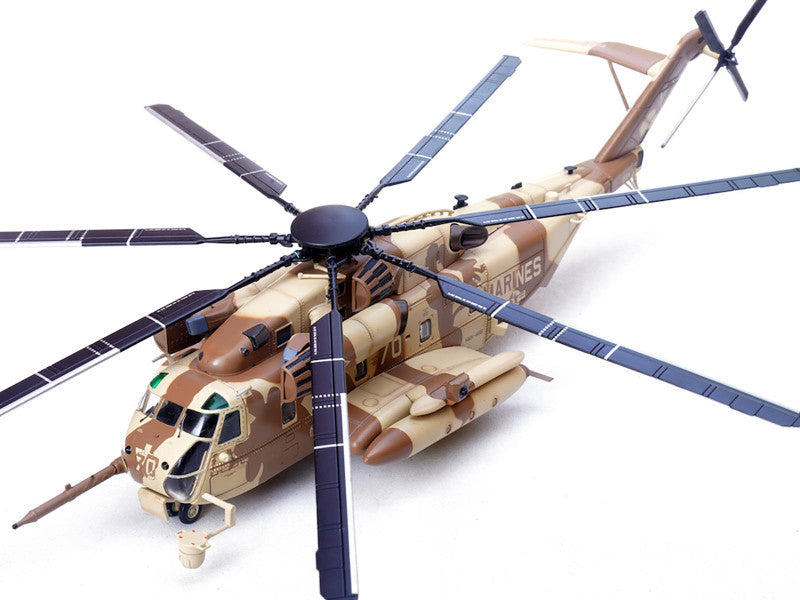 Camouflage helicopter model with visible 'Marines' branding on a white background