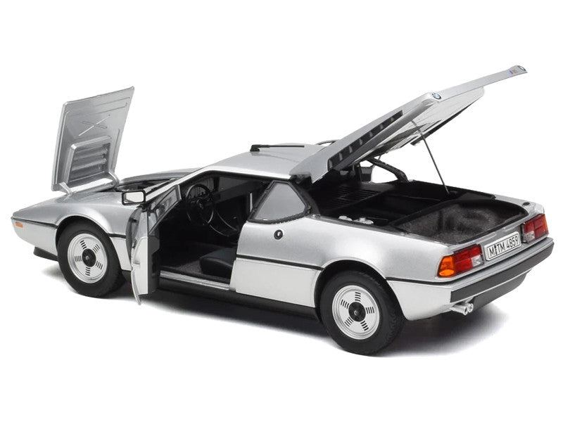 Model car with open doors and trunk on a white background