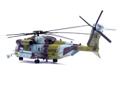 Model helicopter with camouflage design on a white background