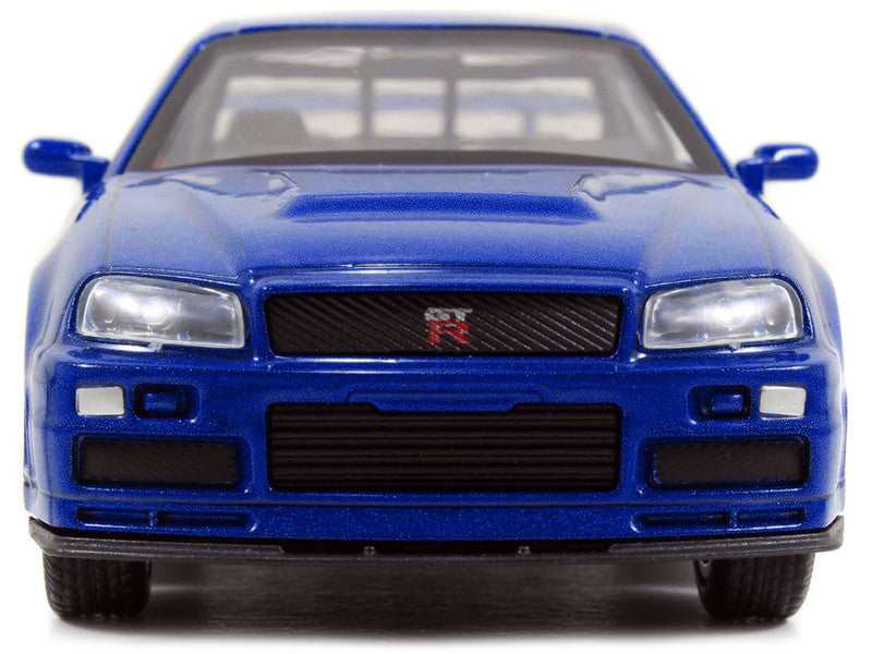 Front view of a blue model car with a visible brand logo on a white background