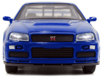 Front view of a blue model car with a visible brand logo on a white background
