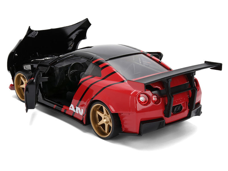 Red and black toy car with gold wheels on a white background