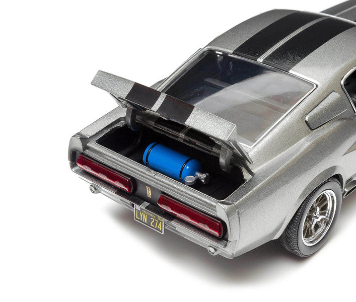 Model car with open trunk showing blue fuel tank on a white background