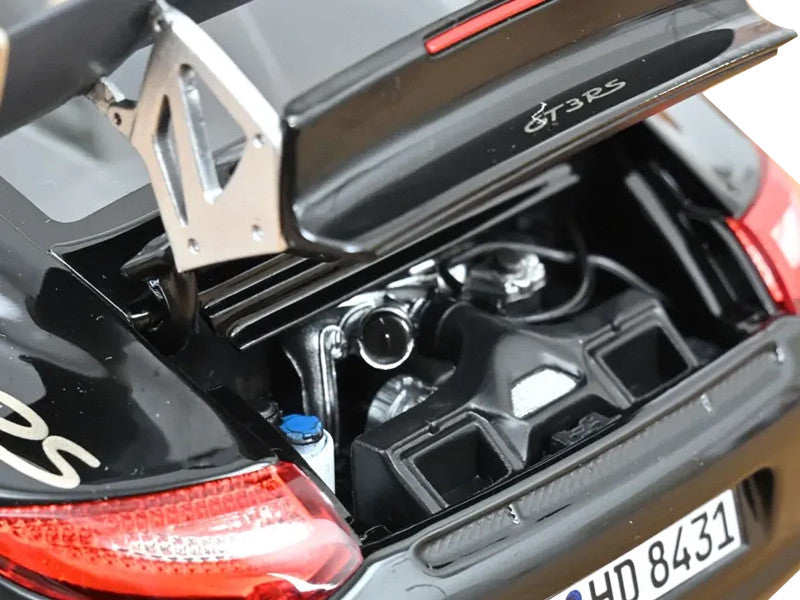 Close-up of a car's rear wing with 'GT3 RS' branding on a black and red vehicle.