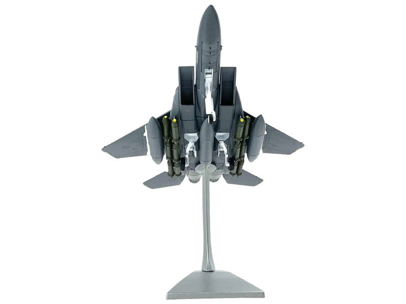 Model of a fighter jet on a stand with a white background