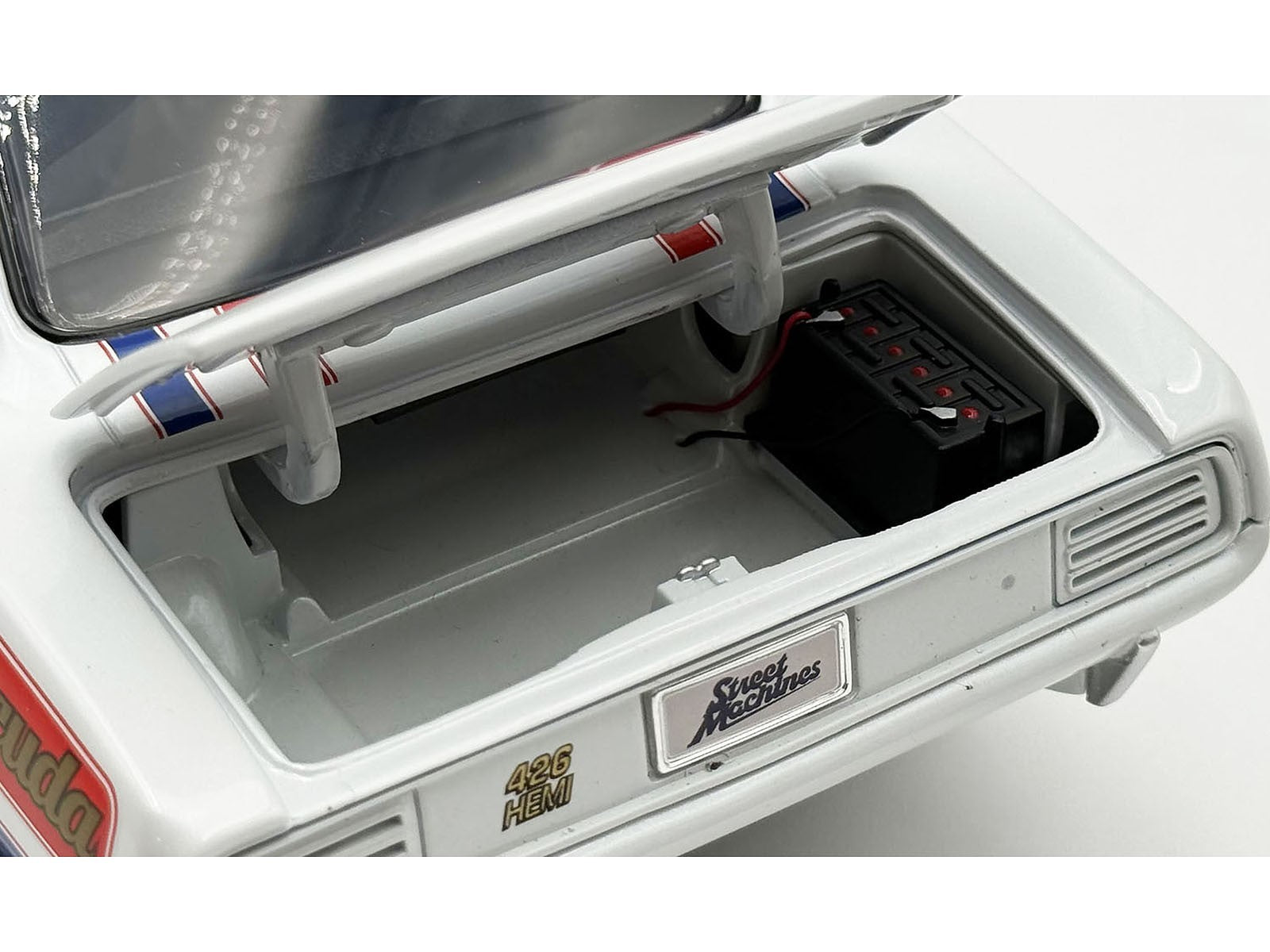Close-up of a model car's interior with visible branding on a white background