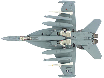 Top-down view of a fighter jet with weapons on a white background