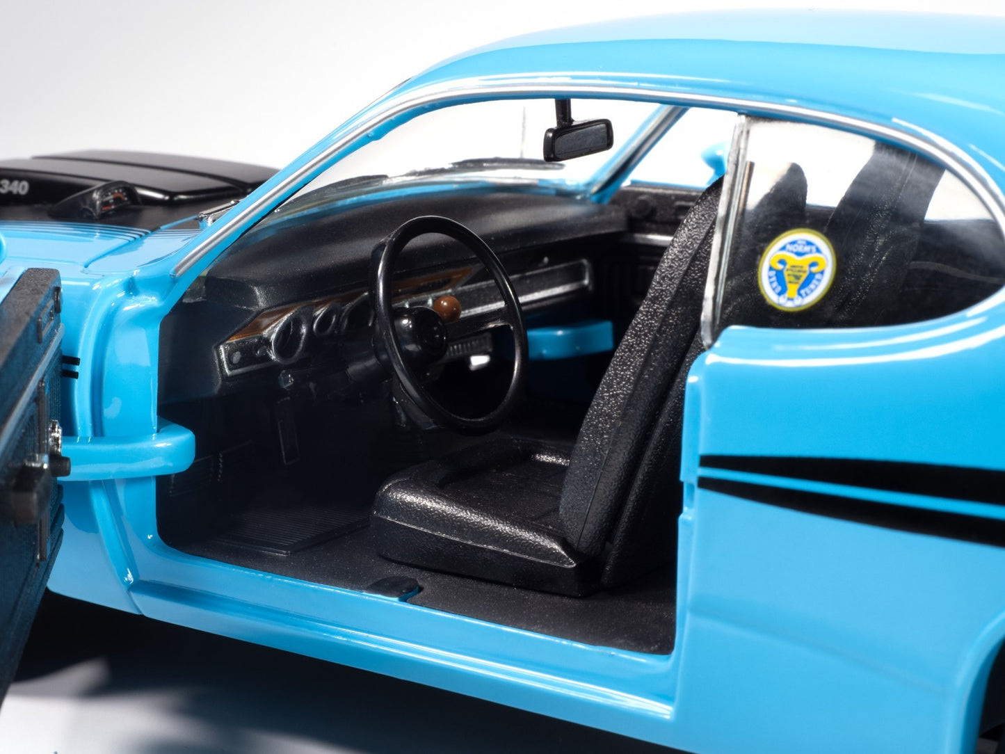 Close-up of a blue car interior with a steering wheel and dashboard.