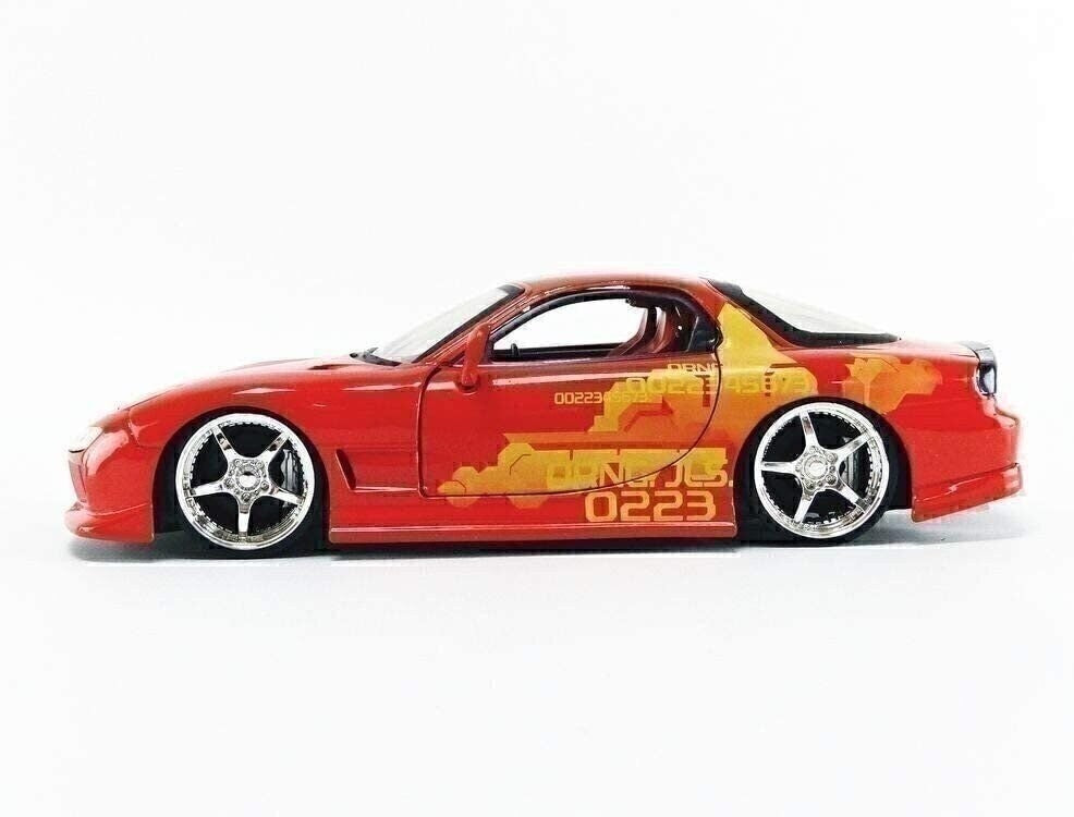 Red toy car with yellow graphics on a white background