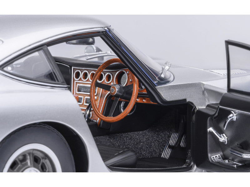 Close-up of a car's interior with steering wheel and dashboard.