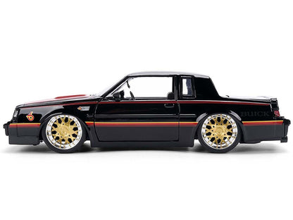 Black Buick car with gold rims on a white background