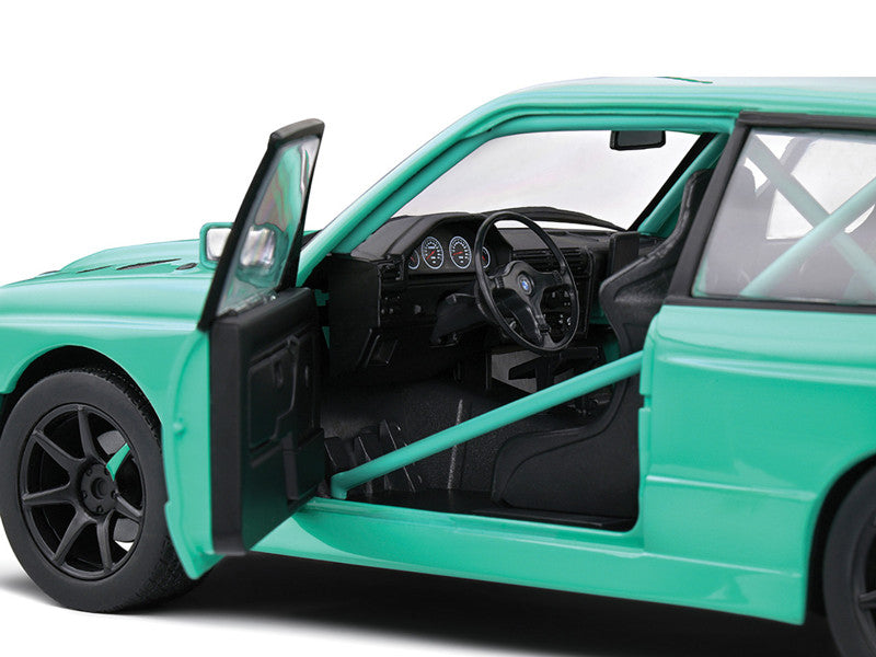 Green car with open door on a white background