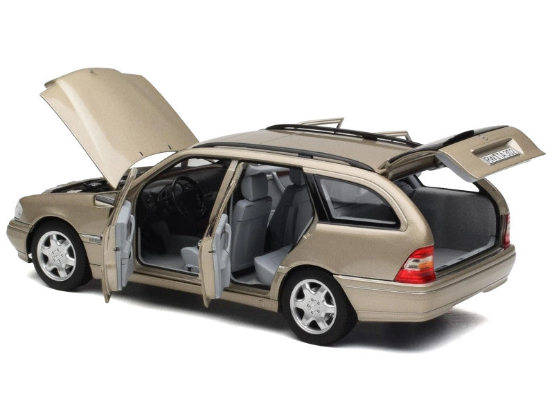 Beige station wagon with open doors and trunk on a white background