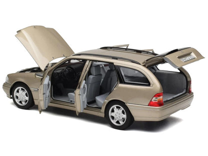 Beige station wagon with open doors and trunk on a white background