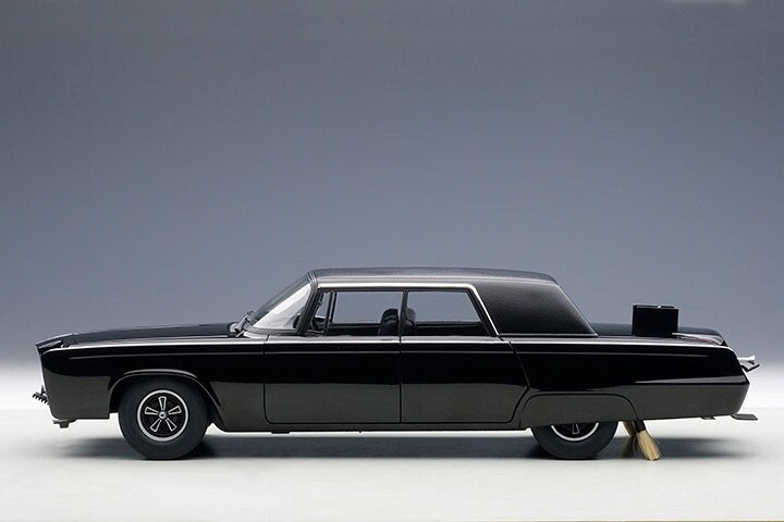 side view of a black model toy car on gray background