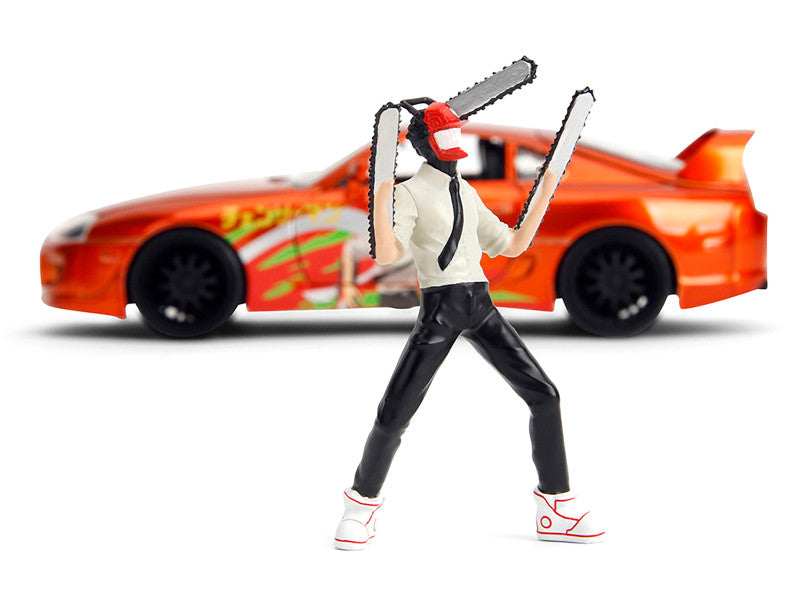 Action figure with chainsaws in front of a toy car on a white background