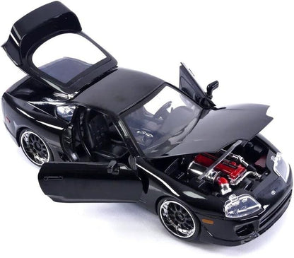 Black model car with open doors and hood on a white background