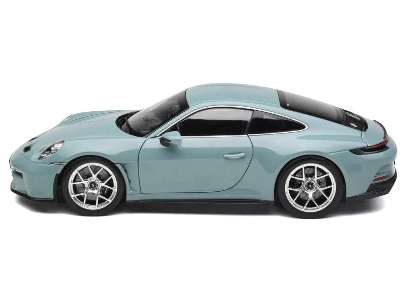 Light blue sports car on a white background