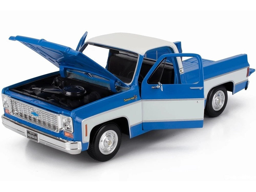 Model truck with open hood on a white background