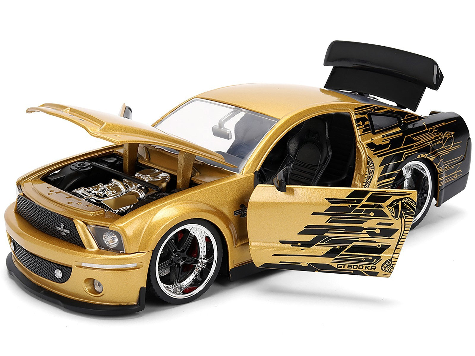 Gold toy car with open door and detailed engine on a white background