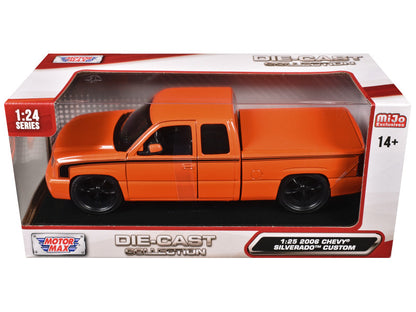 Orange die-cast truck model in packaging with branding on a white background