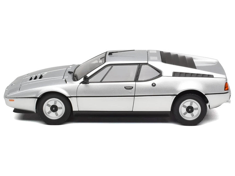 Model of a silver car with black stripes on a white background