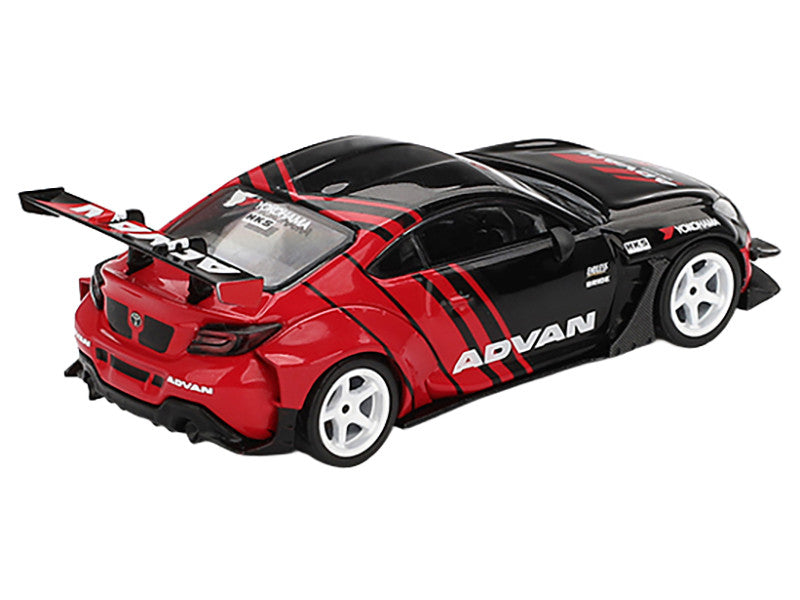 Red and black toy car with 'Advan' branding on a white background