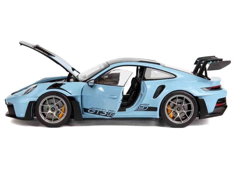 Blue sports car model with open doors on a white background