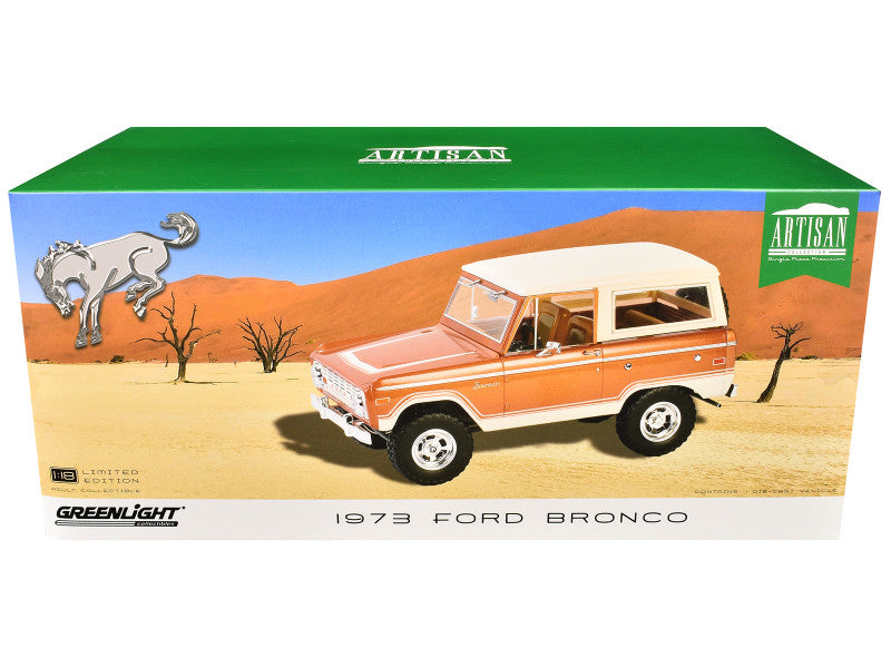 Boxed model of a 1973 Ford Bronco with desert scene design on the packaging.