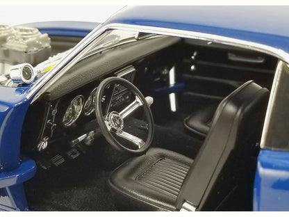 Close-up of a model car's interior with steering wheel and dashboard.