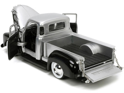 Model of a classic pickup truck with an open bed on a white background