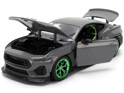 Gray toy car with green wheels on a white background